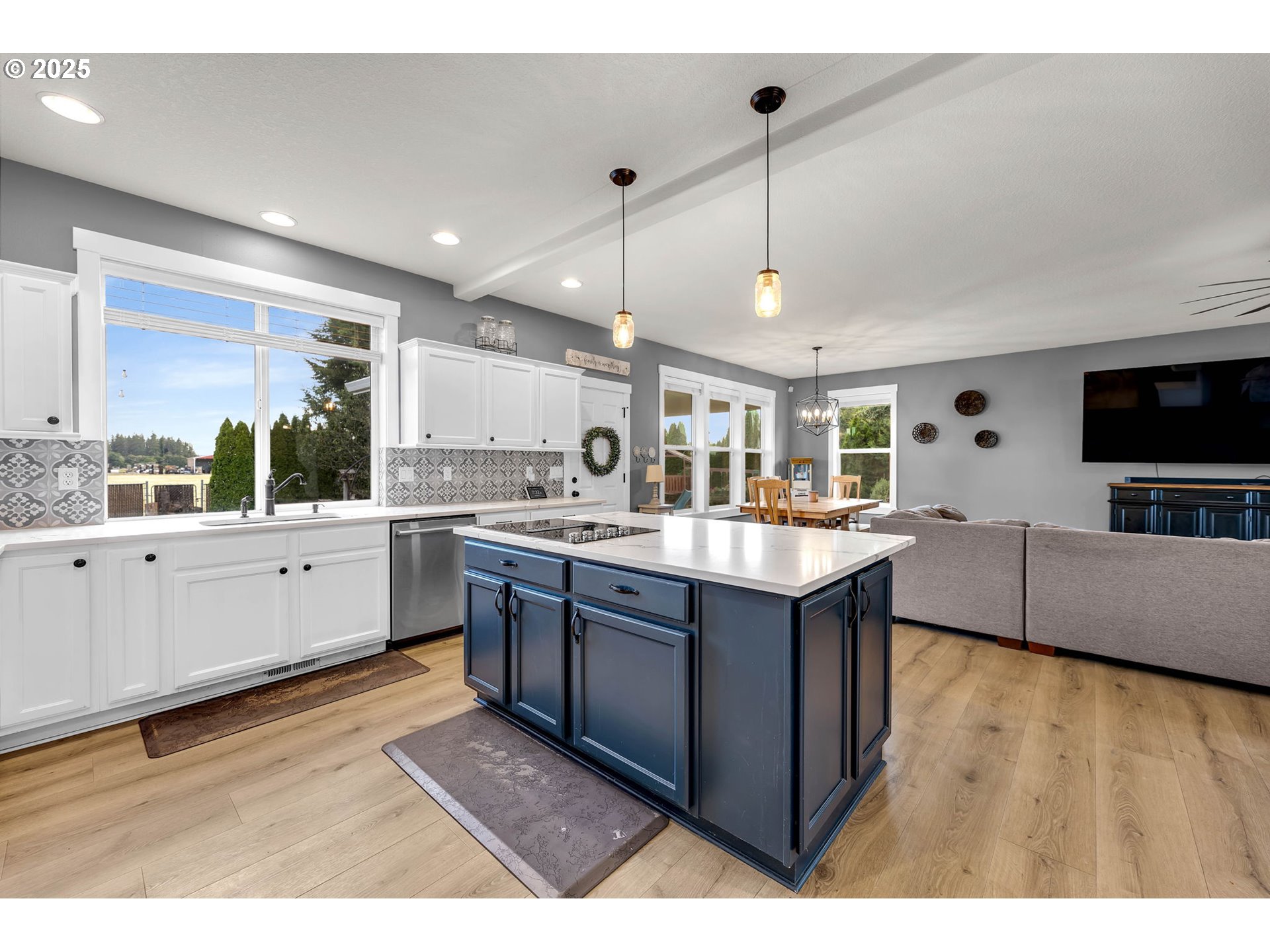 8805 Northeast 179th Street Battle Ground, WA 98604 - Photo 15 of 48 a large kitchen with stainless steel appliances kitchen island granite countertop a sink counter space and a window