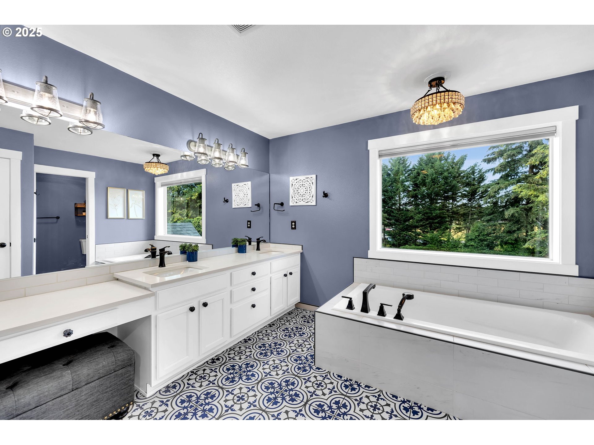 8805 Northeast 179th Street Battle Ground, WA 98604 - Photo 29 of 48 a bathroom with a tub a double vanity sink a window and a mirror