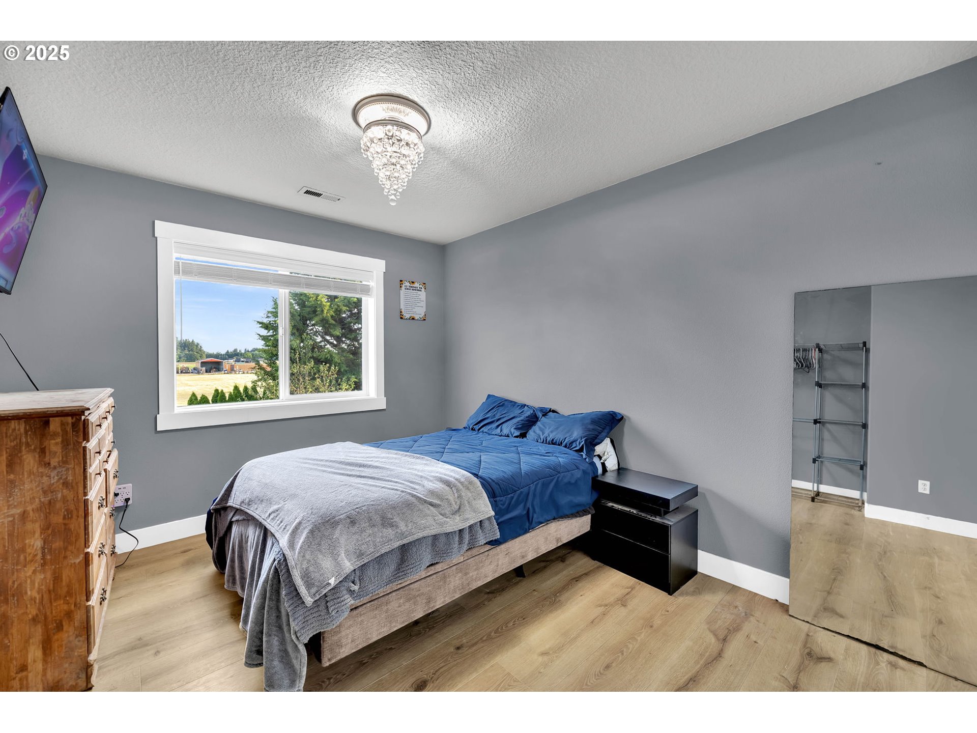 8805 Northeast 179th Street Battle Ground, WA 98604 - Photo 37 of 48 a bedroom with a bed and a night stand