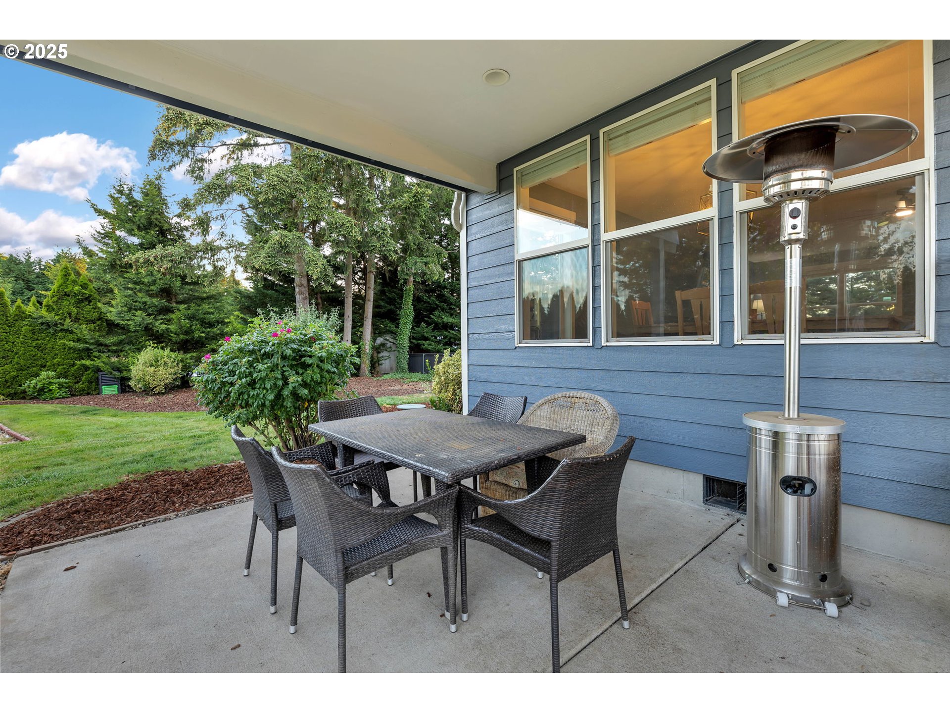 8805 Northeast 179th Street Battle Ground, WA 98604 - Photo 42 of 48 a view of a patio with table and chairs and potted plants