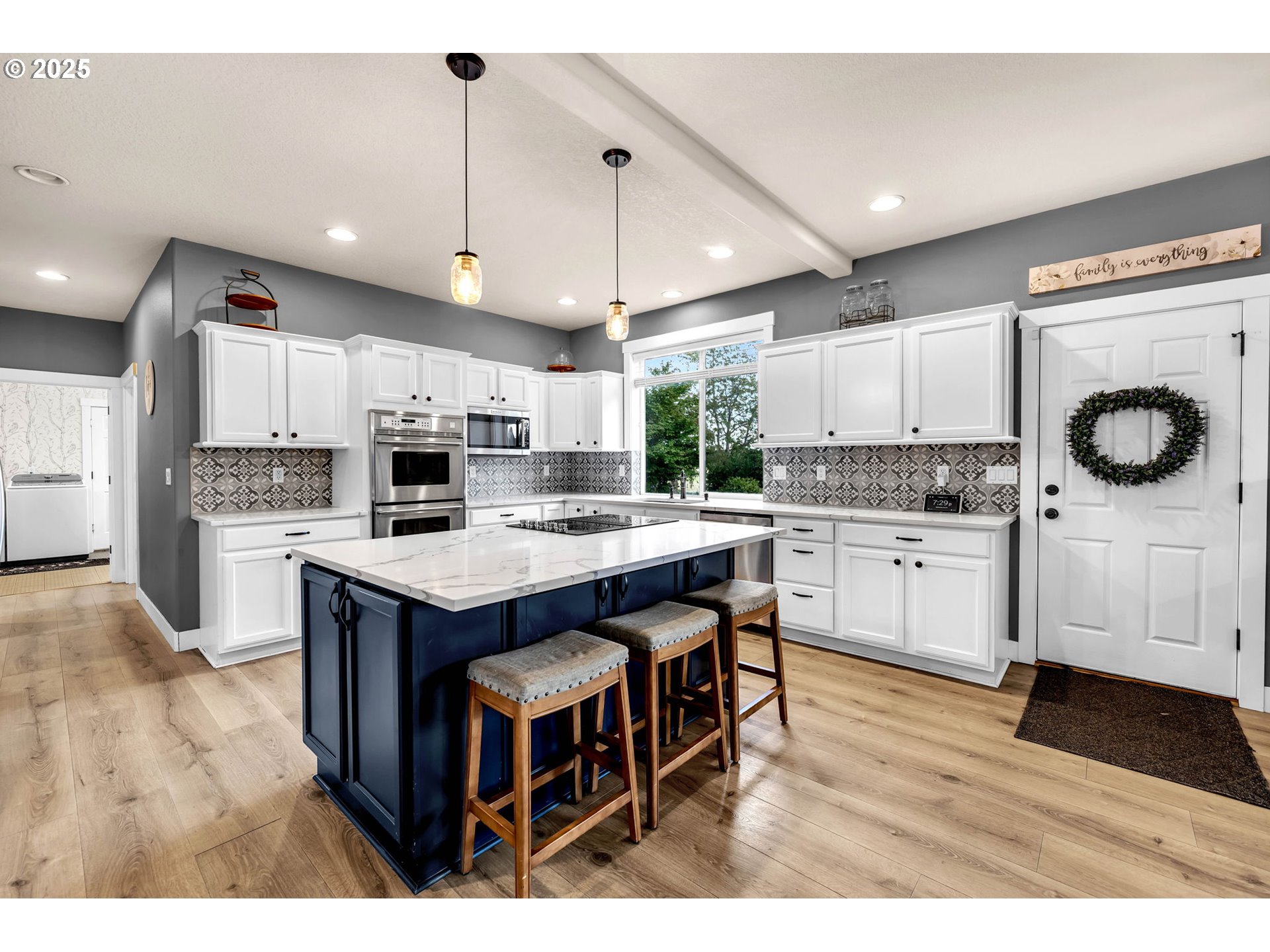 8805 Northeast 179th Street Battle Ground, WA 98604 - Photo 10 of 48 a kitchen with kitchen island granite countertop a stove a sink a microwave a center island and a refrigerator