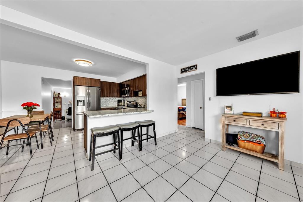 9311 Broad Manor Road Miami, FL 33147 - Photo 14 of 32 a living room with furniture and a flat screen tv