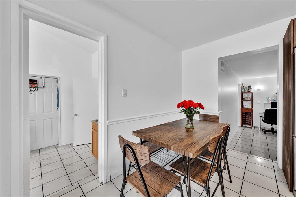 9311 Broad Manor Road Miami, FL 33147 - Photo 16 of 32 a view of a dining room with furniture and wooden floor