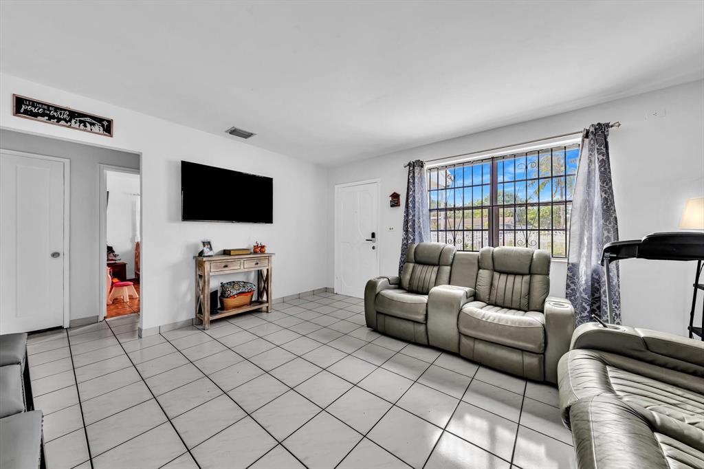 9311 Broad Manor Road Miami, FL 33147 - Photo 17 of 32 a living room with furniture and a flat screen tv