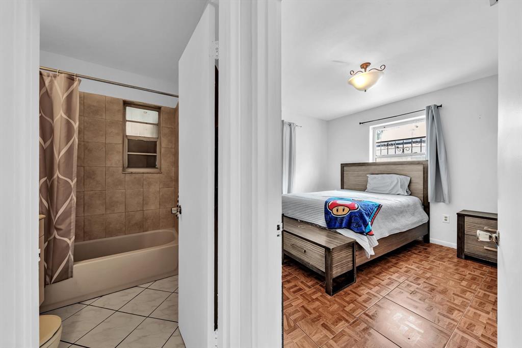 9311 Broad Manor Road Miami, FL 33147 - Photo 18 of 32 a bedroom with a bed and a window