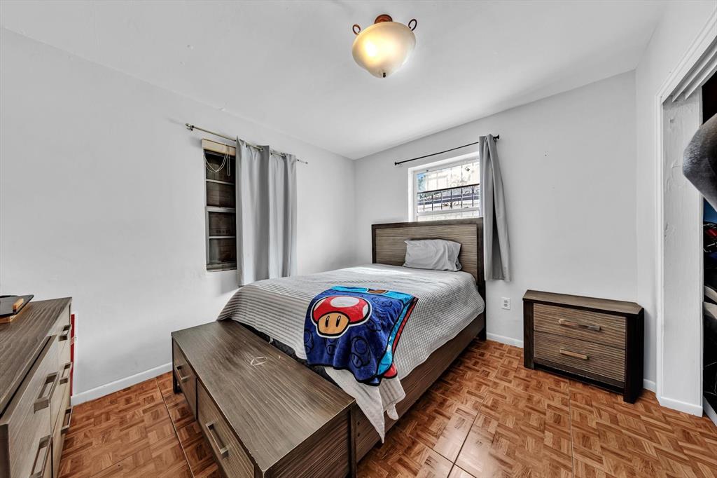 9311 Broad Manor Road Miami, FL 33147 - Photo 19 of 32 a bedroom with a bed and a window