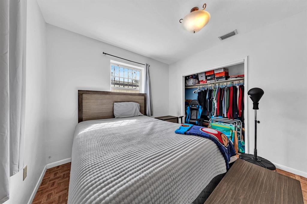 9311 Broad Manor Road Miami, FL 33147 - Photo 20 of 32 a bedroom with a bed and a bookshelf