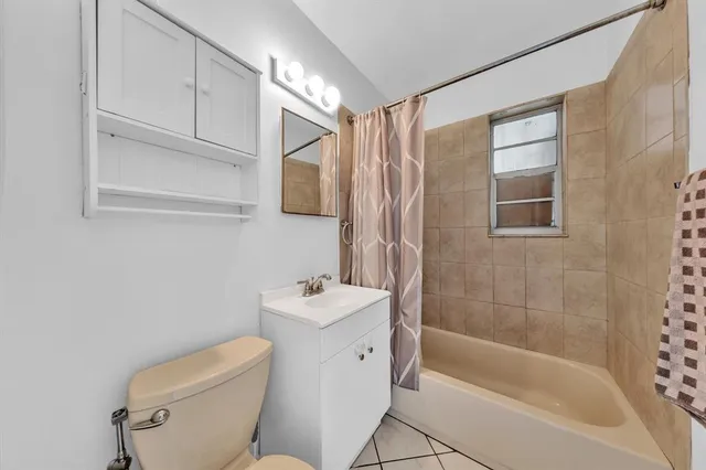 a bathroom with a sink a toilet and bathtub