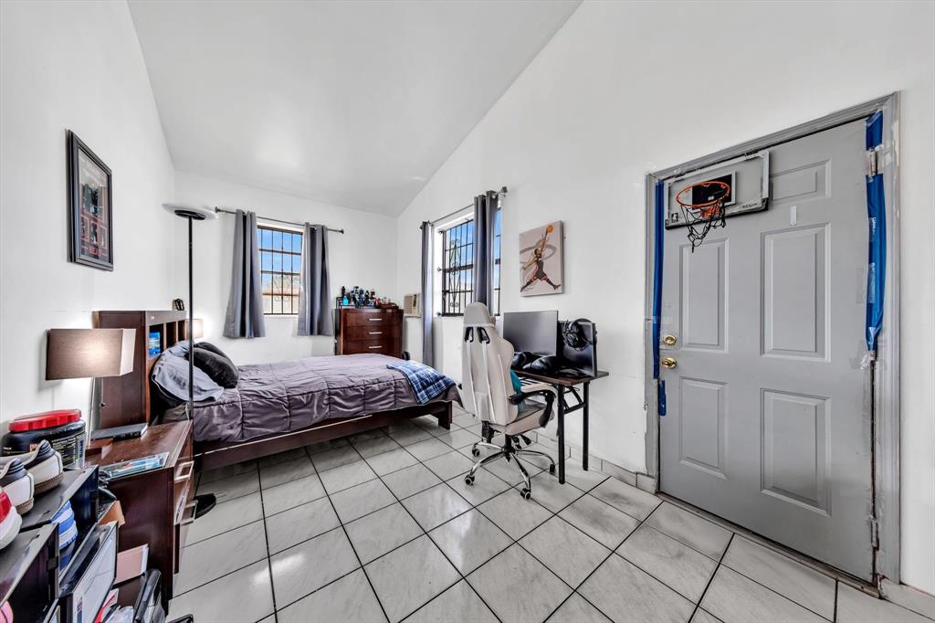 9311 Broad Manor Road Miami, FL 33147 - Photo 22 of 32 a bedroom with a bed and furniture