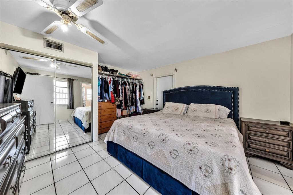 9311 Broad Manor Road Miami, FL 33147 - Photo 25 of 32 a bed room with a bed and a television