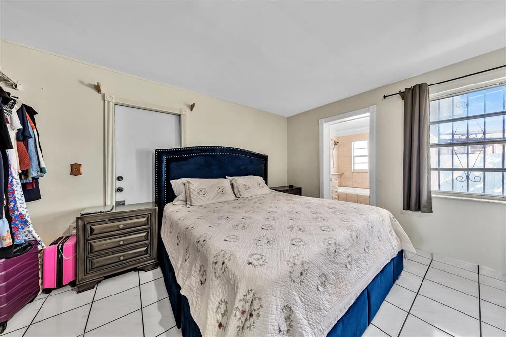 9311 Broad Manor Road Miami, FL 33147 - Photo 26 of 32 a bedroom with bed and a window