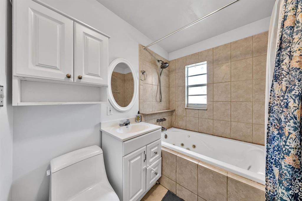 9311 Broad Manor Road Miami, FL 33147 - Photo 29 of 32 a bathroom with a sink a toilet and bathtub