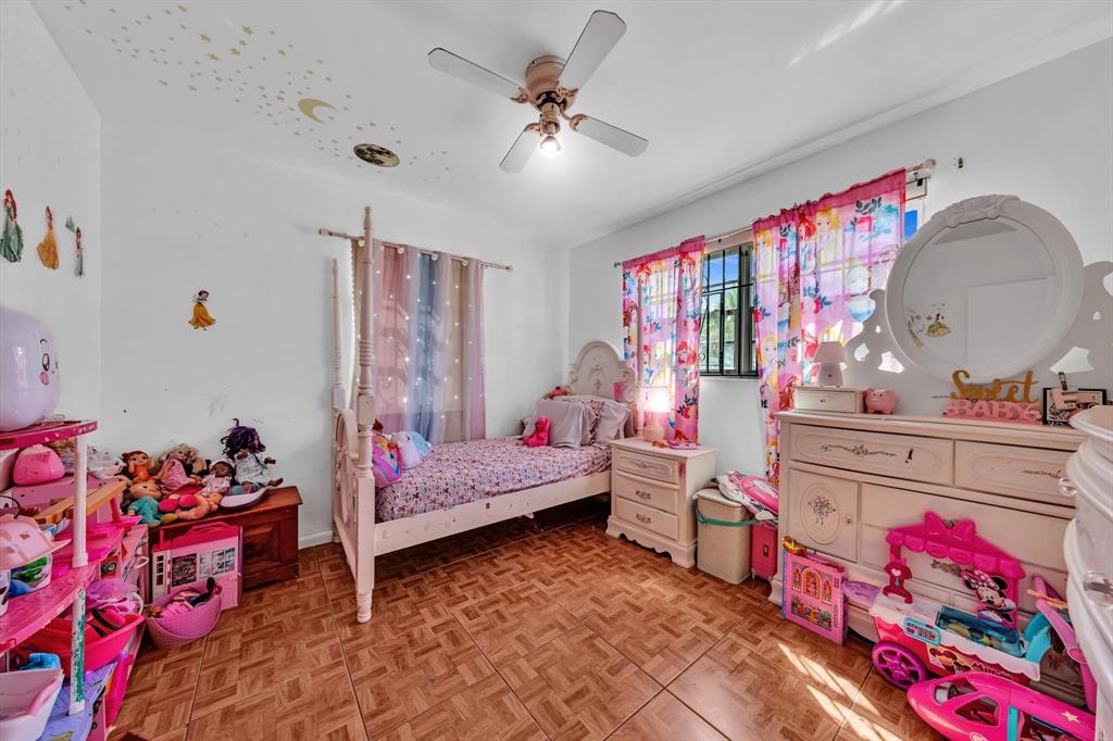 9311 Broad Manor Road Miami, FL 33147 - Photo 30 of 32 a bedroom with furniture and a baby crib