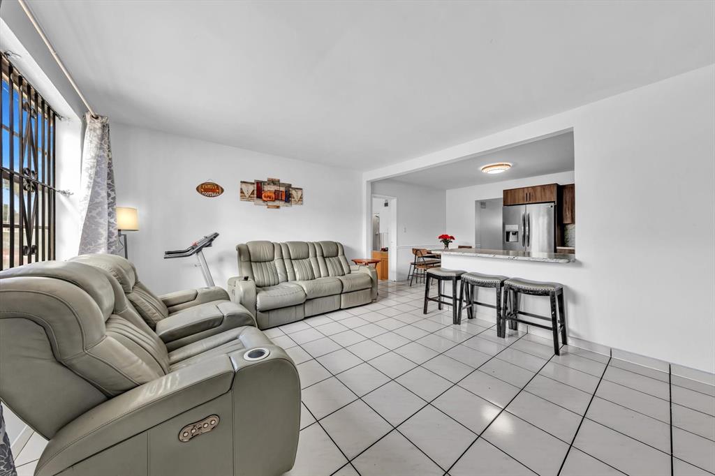 9311 Broad Manor Road Miami, FL 33147 - Photo 9 of 32 a living room with furniture and a table