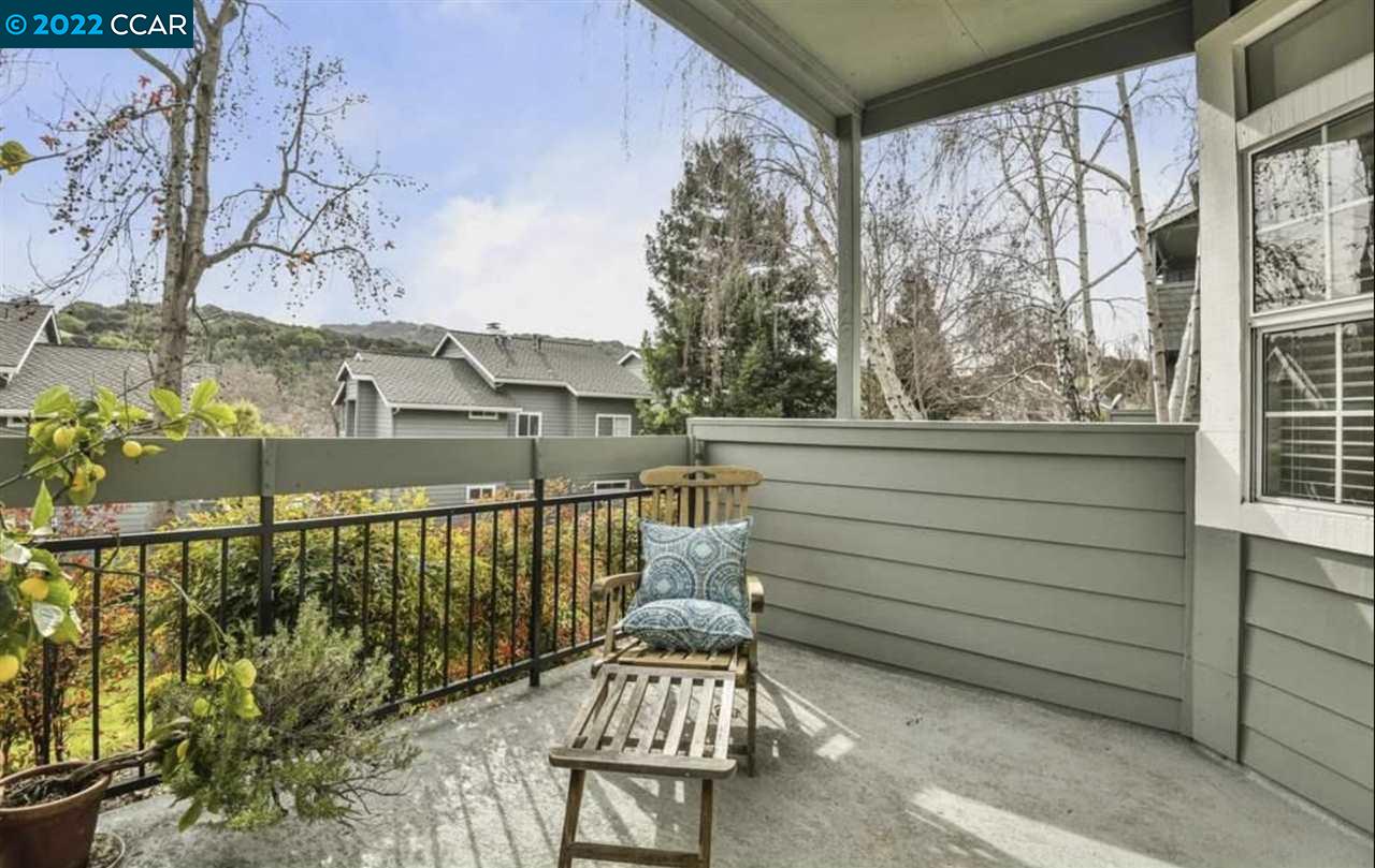 a view of a chairs and table in the balcony