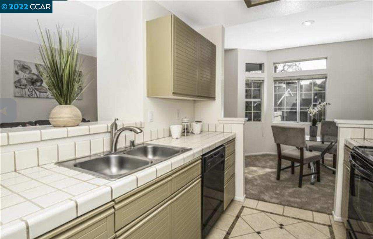 7650 Canyon Meadows Circle, Unit G Pleasanton, CA 94588 - Photo 13 of 24 a kitchen with a sink and a refrigerator