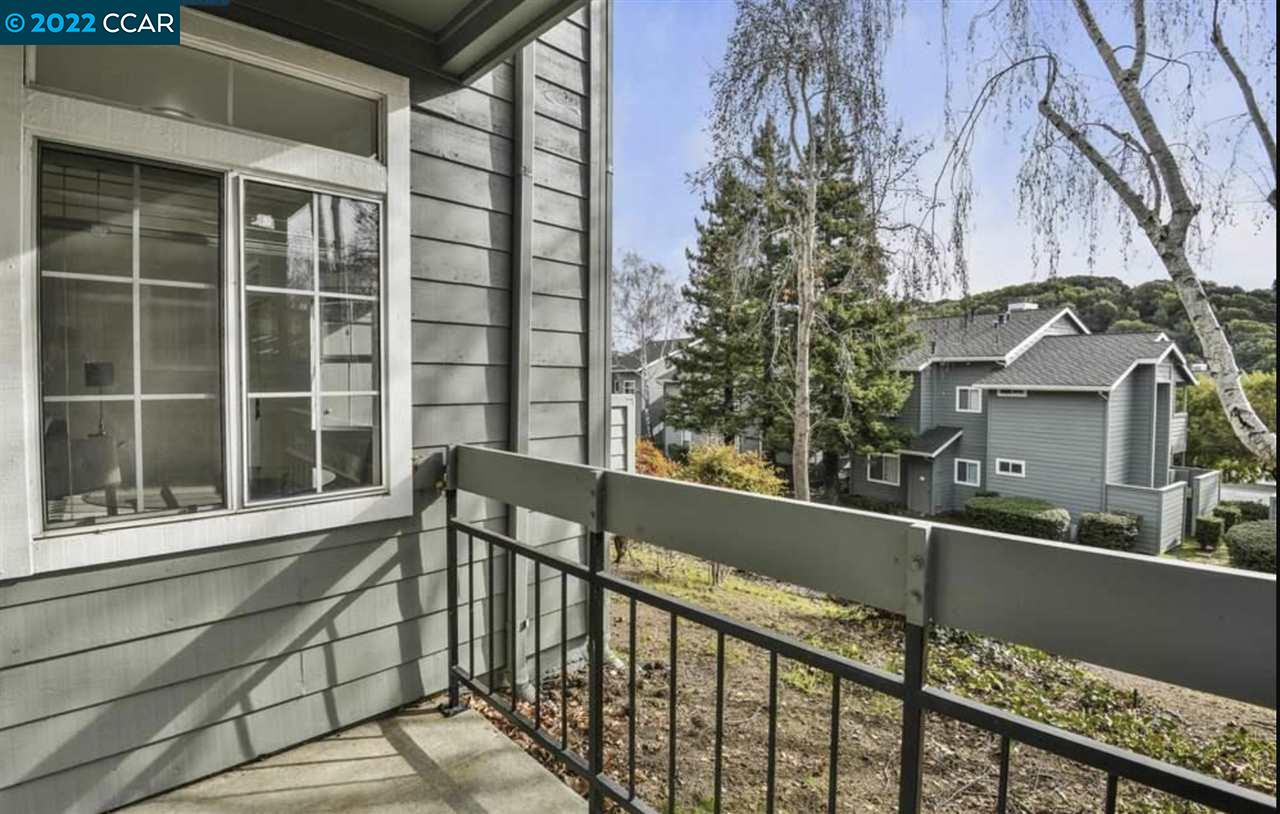 7650 Canyon Meadows Circle, Unit G Pleasanton, CA 94588 - Photo 16 of 24 a view of a balcony with a large window and wooden fence