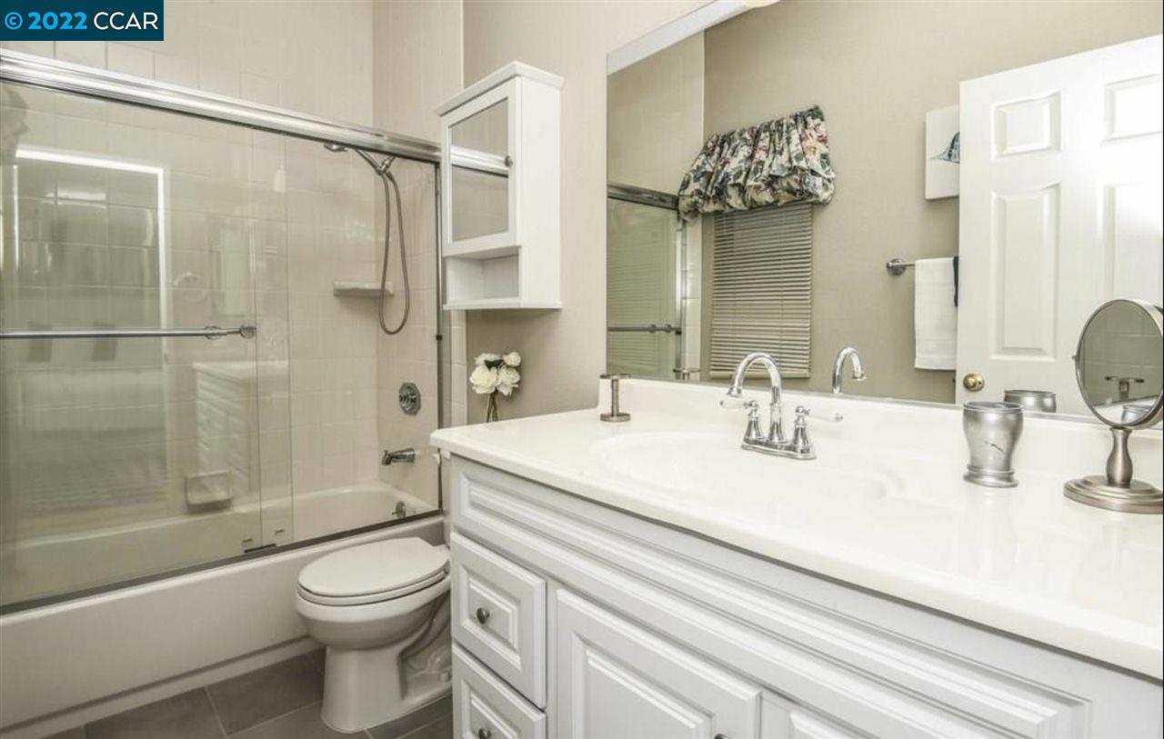 7650 Canyon Meadows Circle, Unit G Pleasanton, CA 94588 - Photo 19 of 24 a bathroom with a sink a toilet and shower