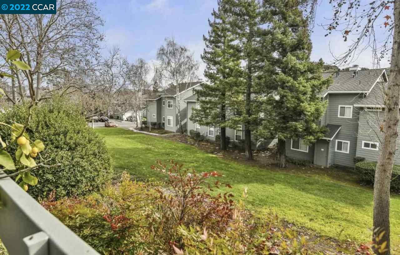 7650 Canyon Meadows Circle, Unit G Pleasanton, CA 94588 - Photo 2 of 24 a view of a garden with a brick wall