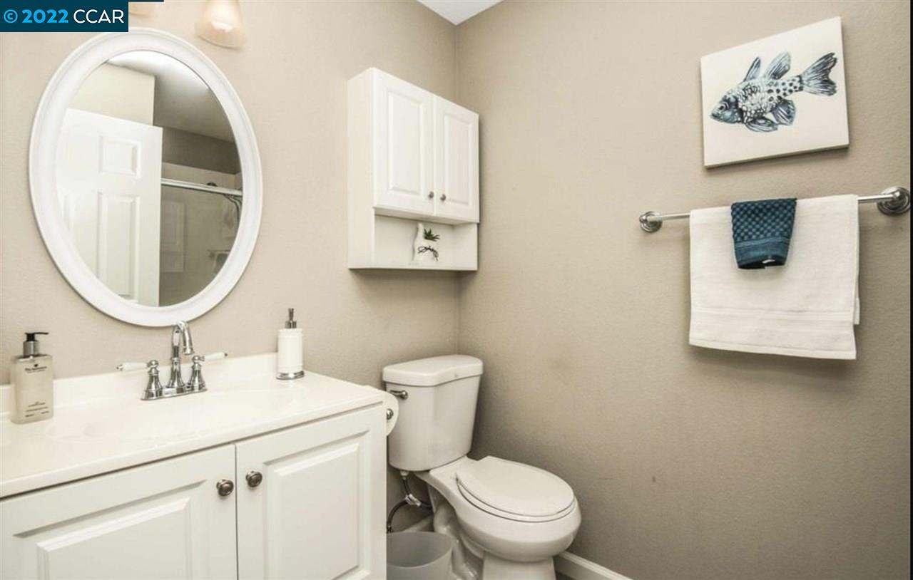 7650 Canyon Meadows Circle, Unit G Pleasanton, CA 94588 - Photo 21 of 24 a bathroom with a sink mirror and toilet