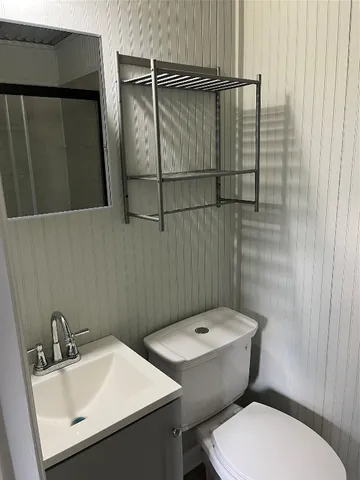 a bathroom with a sink toilet and vanity