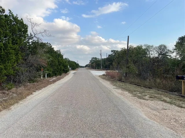 a view of a road with a yard