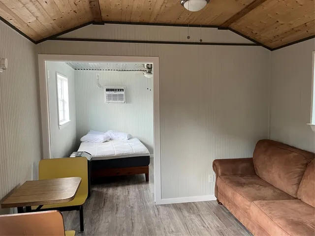 a bedroom with a bed and a chair