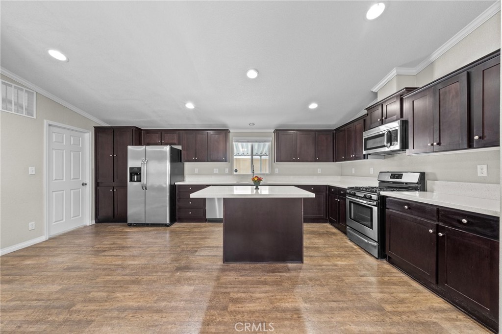 3909 Reche Road, Unit 194 Fallbrook, CA 92028 - Photo 14 of 37 a large kitchen with stainless steel appliances kitchen island granite countertop a stove and a refrigerator