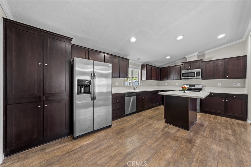 3909 Reche Road, Unit 194 Fallbrook, CA 92028 - Photo 2 of 37 a large kitchen with stainless steel appliances granite countertop a refrigerator and a stove top oven