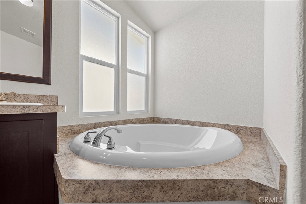 3909 Reche Road, Unit 194 Fallbrook, CA 92028 - Photo 22 of 37 a bath tub sitting in a bathroom next to a window