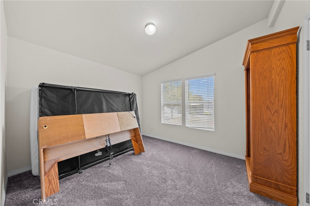 3909 Reche Road, Unit 194 Fallbrook, CA 92028 - Photo 24 of 37 a bedroom with a bed and window