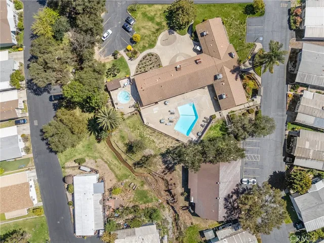an aerial view of a house with a yard and trees