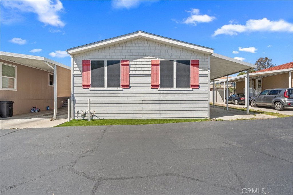 3909 Reche Road, Unit 194 Fallbrook, CA 92028 - Photo 6 of 37 a front view of a house with a road