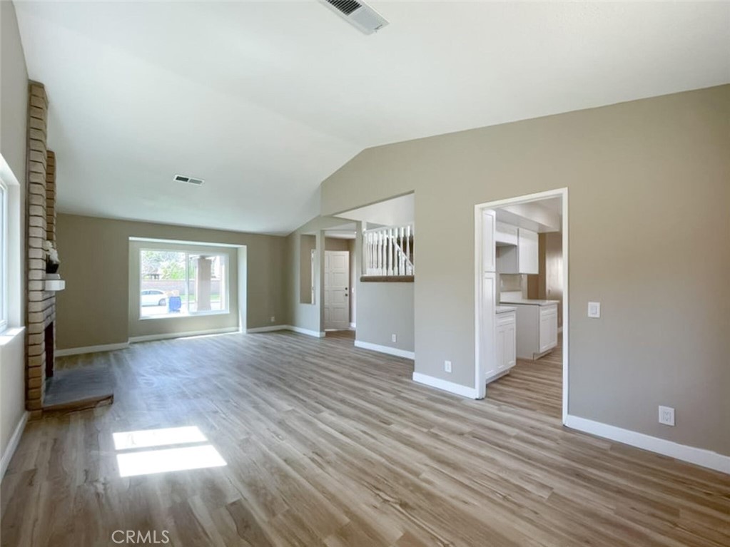 43856 Windsor Place Lancaster, CA 93536 - Photo 12 of 39 an empty room with wooden floor and windows