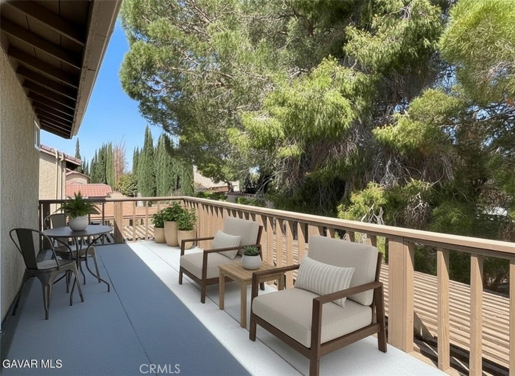 43856 Windsor Place Lancaster, CA 93536 - Photo 20 of 39 a balcony with wooden floor and outdoor seating