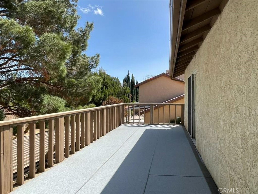 43856 Windsor Place Lancaster, CA 93536 - Photo 21 of 39 a balcony with wooden floor
