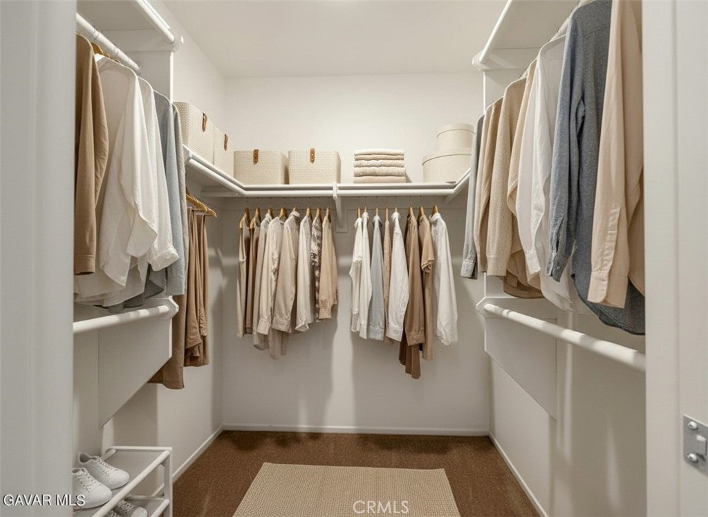 43856 Windsor Place Lancaster, CA 93536 - Photo 24 of 39 a view of walk in closet with clothes and shoes