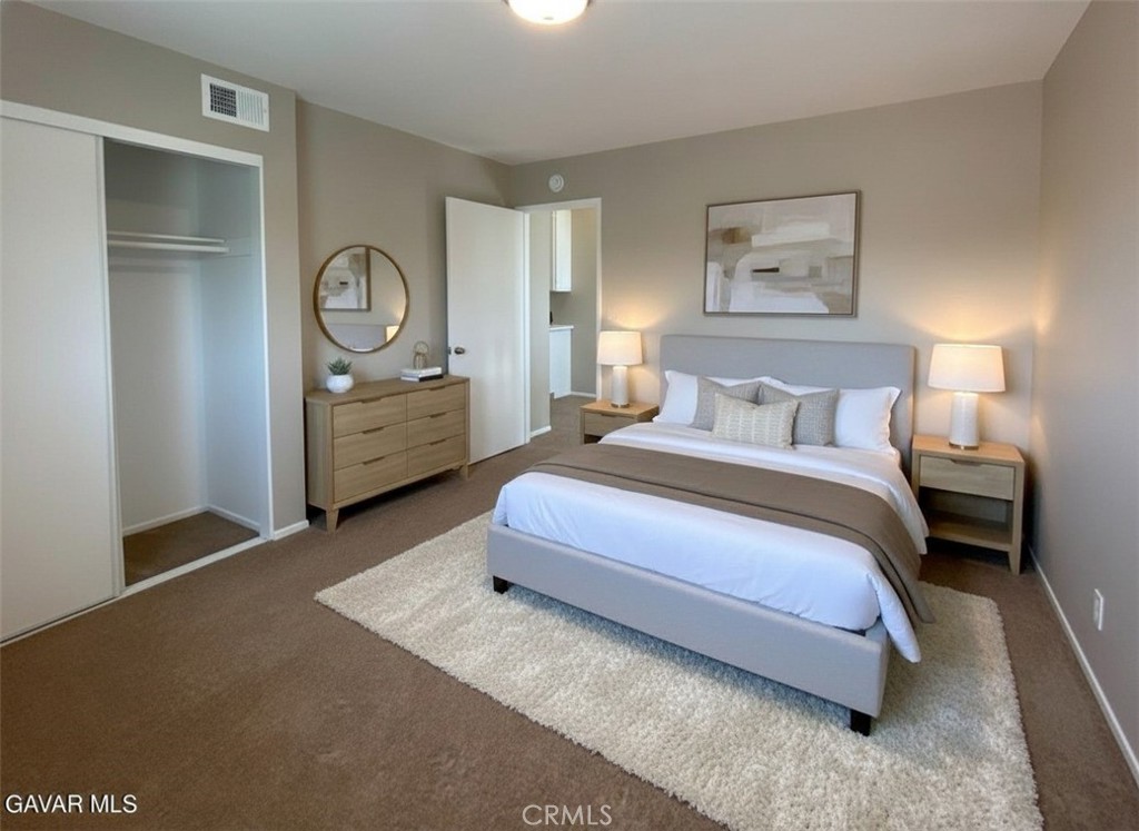 43856 Windsor Place Lancaster, CA 93536 - Photo 27 of 39 a spacious bedroom with a bed and painting on the wall