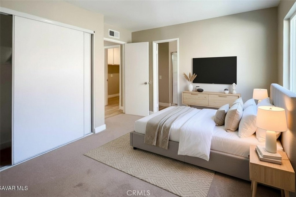 43856 Windsor Place Lancaster, CA 93536 - Photo 30 of 39 a bedroom with a bed and a flat screen tv