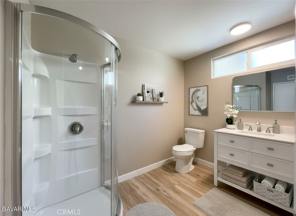 43856 Windsor Place Lancaster, CA 93536 - Photo 31 of 39 a bathroom with a sink a toilet a shower and a mirror