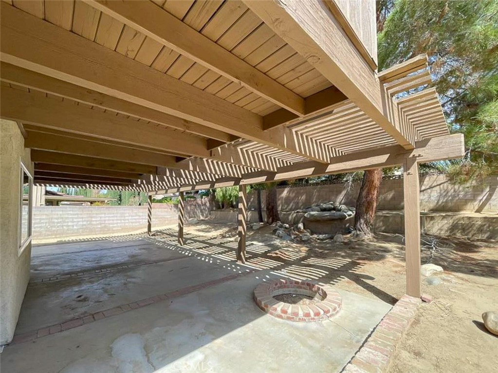 43856 Windsor Place Lancaster, CA 93536 - Photo 35 of 39 a view of a patio with table and chairs with wooden floor and fence