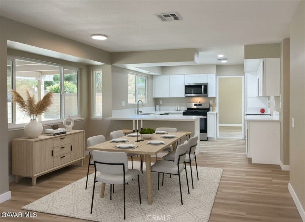43856 Windsor Place Lancaster, CA 93536 - Photo 6 of 39 a kitchen with granite countertop a sink stove and refrigerator