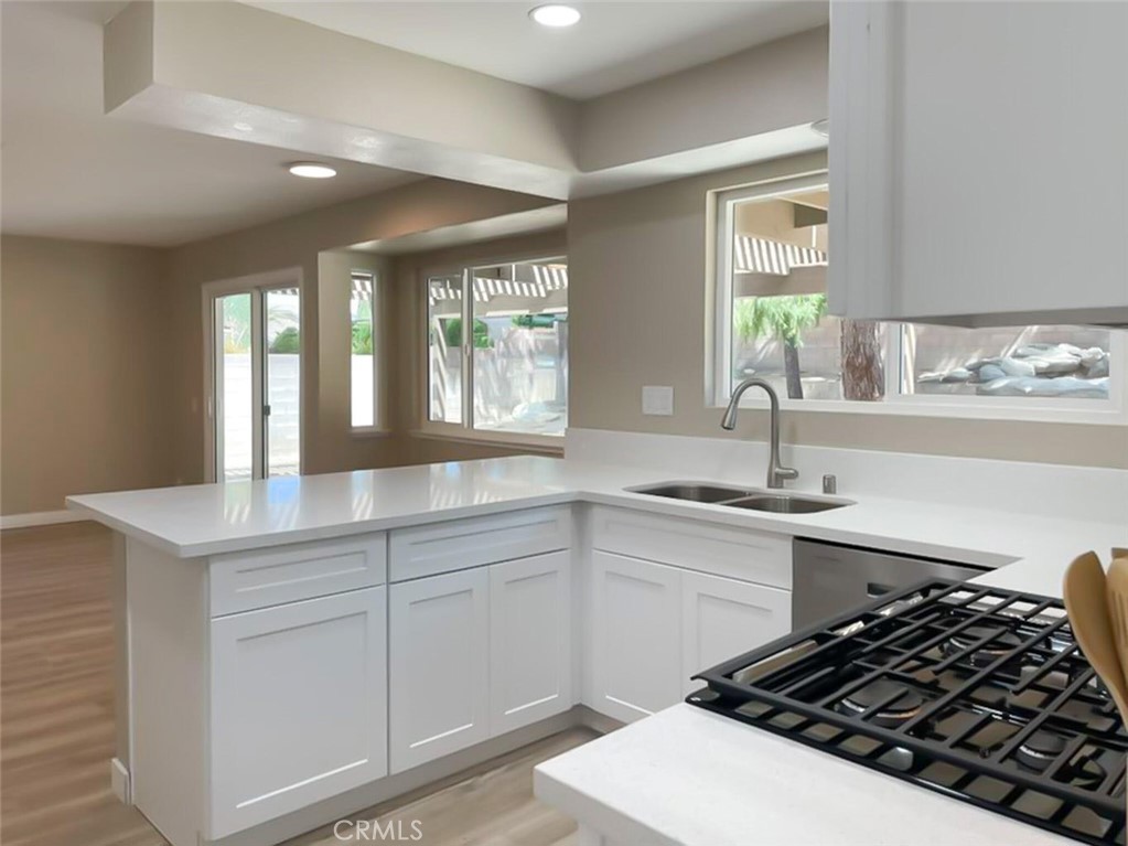 43856 Windsor Place Lancaster, CA 93536 - Photo 9 of 39 a kitchen with a sink stove and cabinets