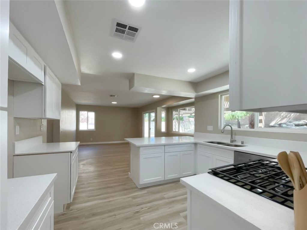 43856 Windsor Place Lancaster, CA 93536 - Photo 10 of 39 a kitchen with stainless steel appliances granite countertop a sink stove and cabinets