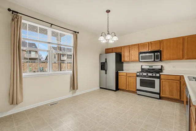 a kitchen with stainless steel appliances a stove and a refrigerator
