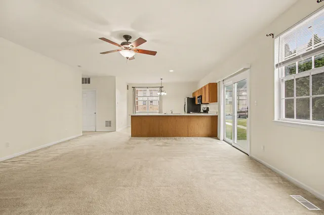 a view of a kitchen with furniture and a ceiling fan
