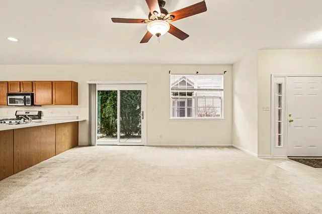 a view of a kitchen with microwave and windows