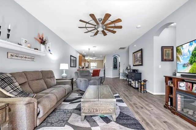 a living room with furniture and a flat screen tv with wooden floor