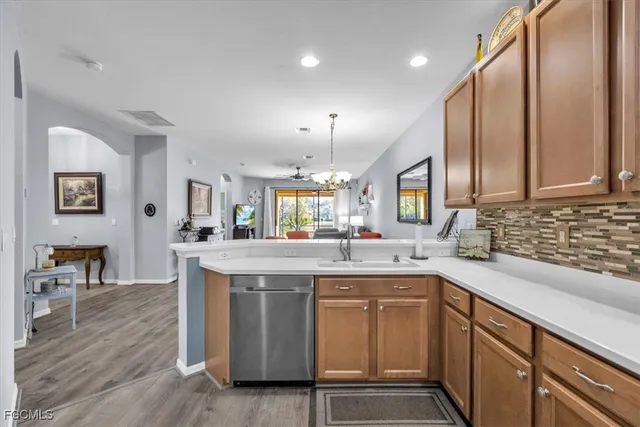 a kitchen with stainless steel appliances granite countertop a sink stove and wooden floor