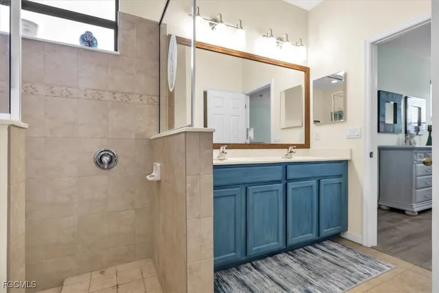 a bathroom with a double vanity sink and a mirror